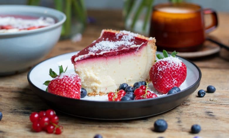 closeup shot of cheesecake with jelly decorated with strawberries and berries